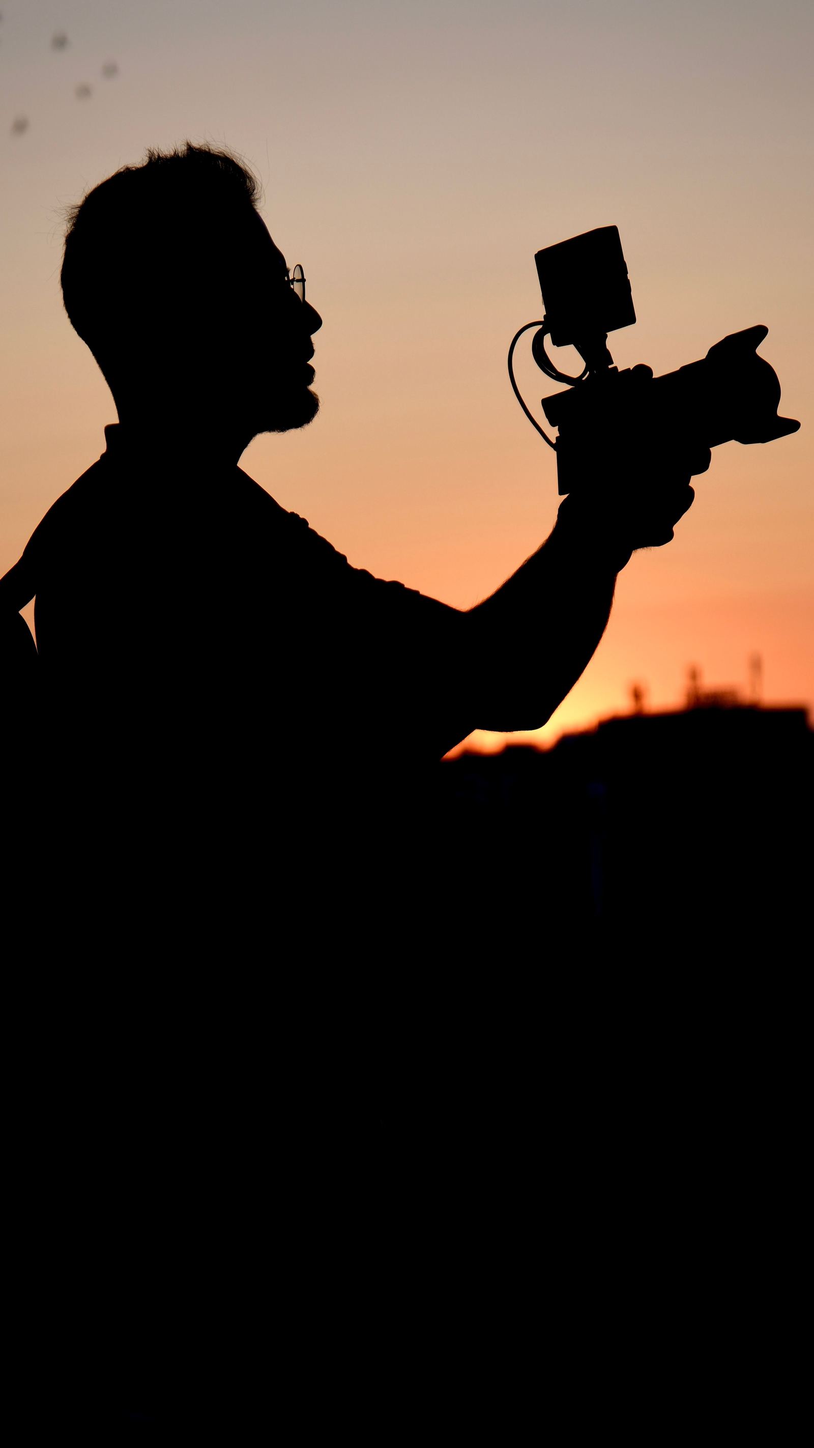 Camera operator at sunset